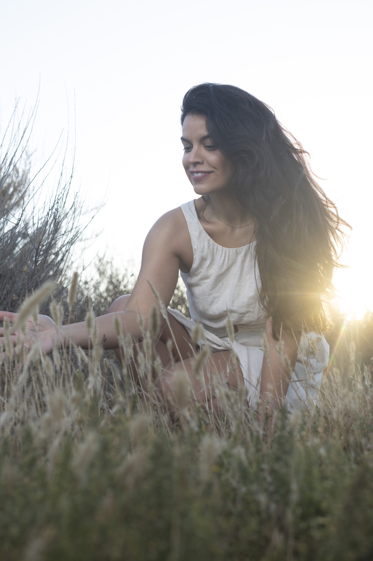 Sunlit portrait of Kimberly in a natural field setting